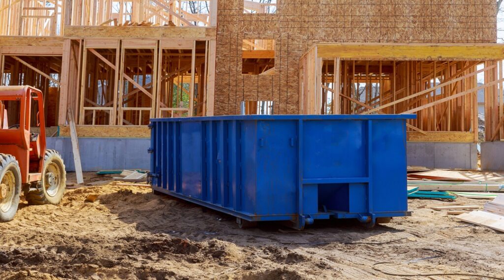 What's the Best Dumpster Size for a Construction Project? 1 Blur dumpster, recycle waste and garbage bins near new construction site of appartment houses building