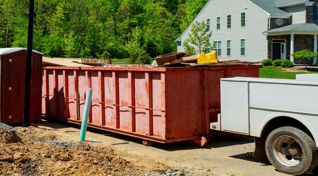 Affordable Dumpster Rentals in Columbus, OH for Residential Projects 1 garbage containers near the new home, Red containers, recycling and waste construction site on the background